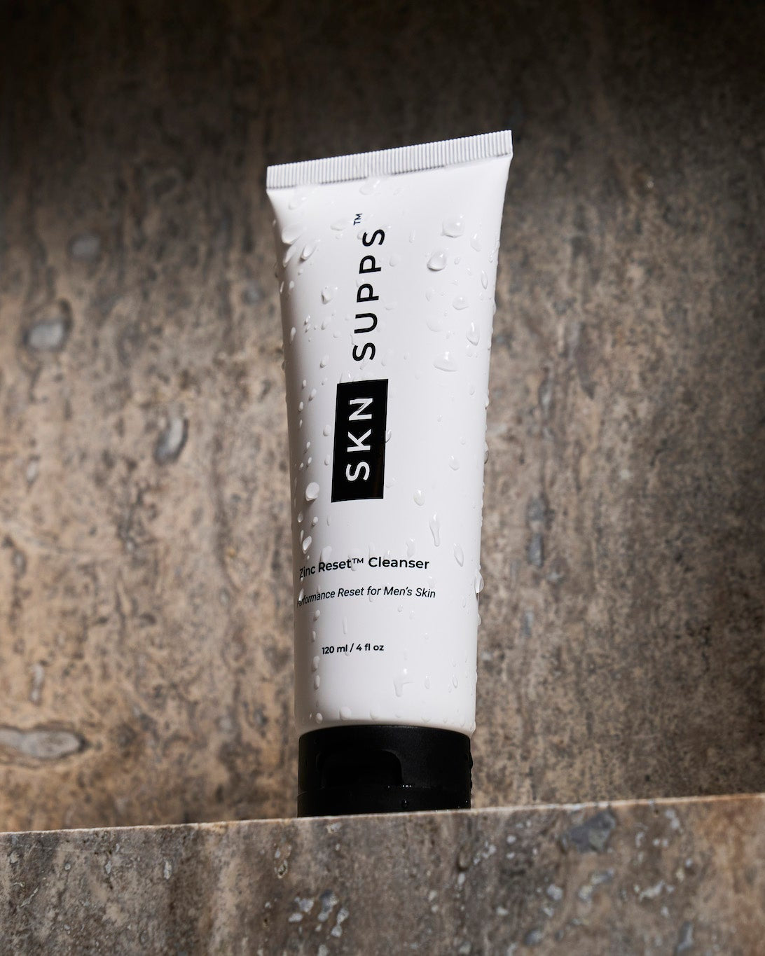 SKN SUPPS Zinc Reset face wash for men with zinc PCA on stone surface.