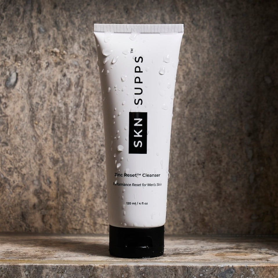 SKN SUPPS Zinc Reset face wash for men with zinc PCA on stone surface.