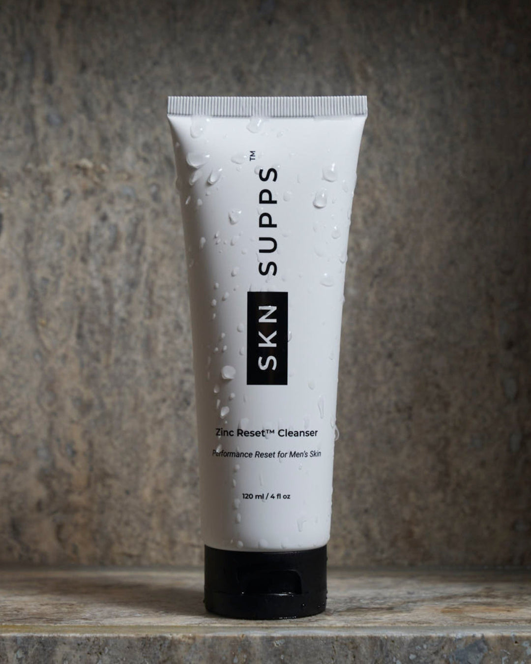 SKN SUPPS Zinc Reset face wash for men with zinc PCA on stone surface.