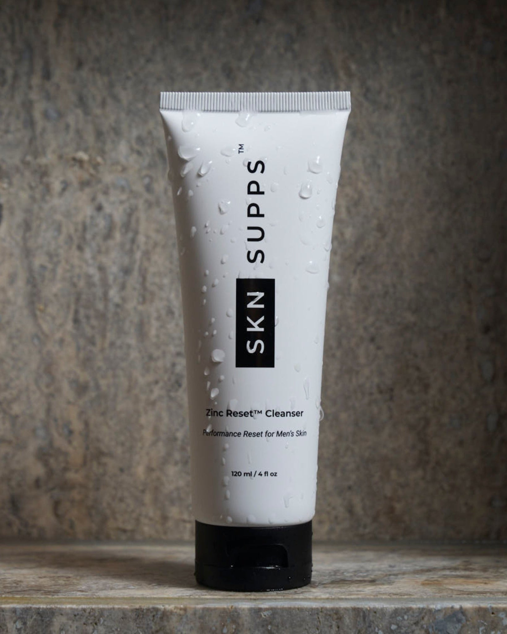 SKN SUPPS Zinc Reset face wash for men with zinc PCA on stone surface.